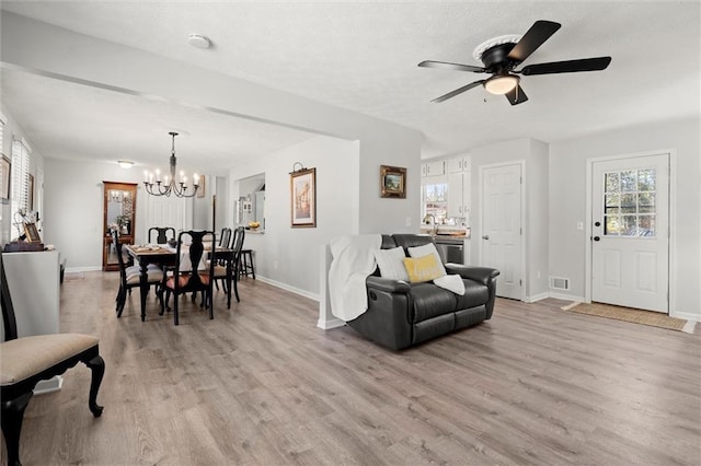 living area featuring baseboards and light wood-style floors