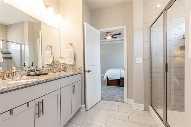 ensuite bathroom with ensuite bath, a sink, a ceiling fan, and a stall shower