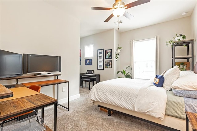 bedroom featuring baseboards, ceiling fan, visible vents, and light colored carpet