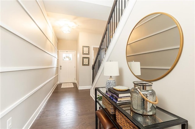 entryway featuring baseboards, stairway, and dark wood finished floors