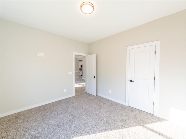 unfurnished bedroom featuring light carpet