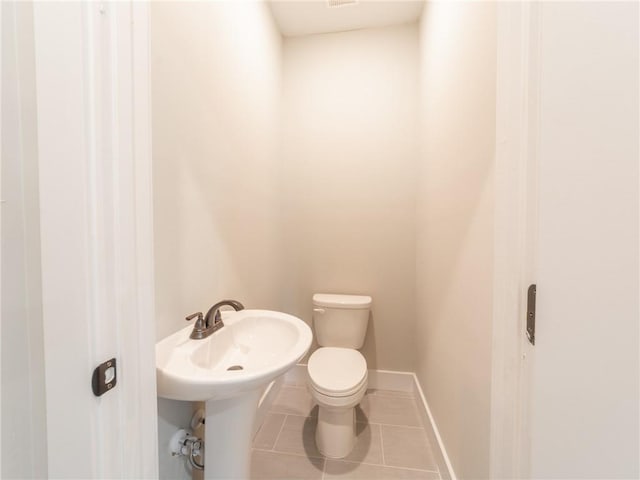 bathroom featuring toilet and tile patterned floors