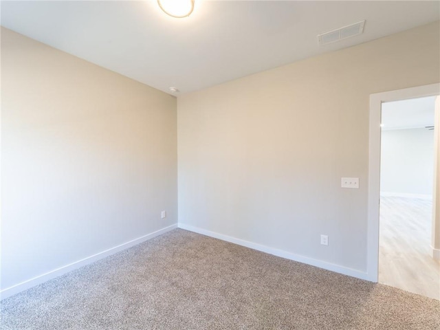 empty room featuring light colored carpet