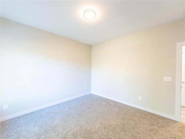 unfurnished room with light carpet