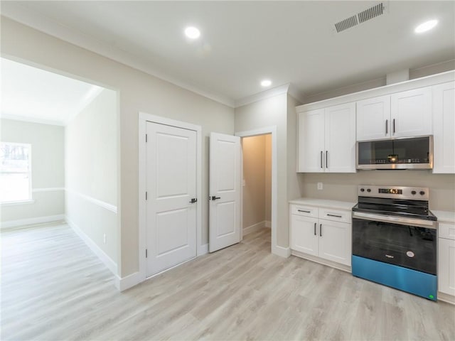 kitchen with light hardwood / wood-style floors, crown molding, white cabinets, and stainless steel appliances