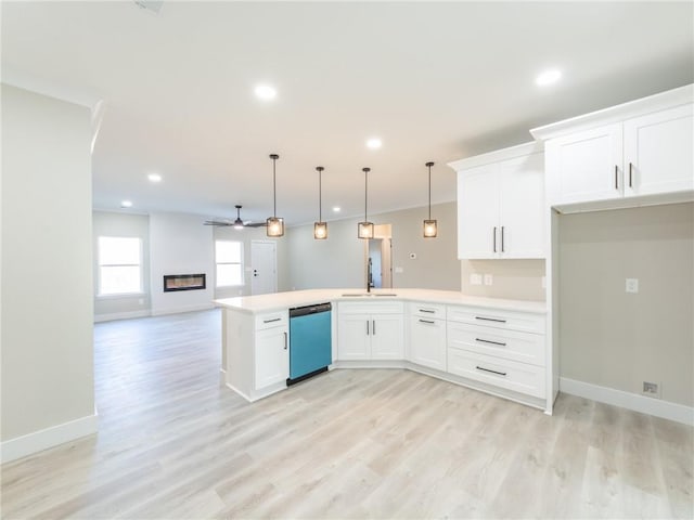 kitchen with ceiling fan, dishwasher, sink, white cabinetry, and hanging light fixtures