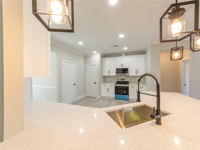 kitchen featuring light stone countertops, electric stove, pendant lighting, and white cabinetry