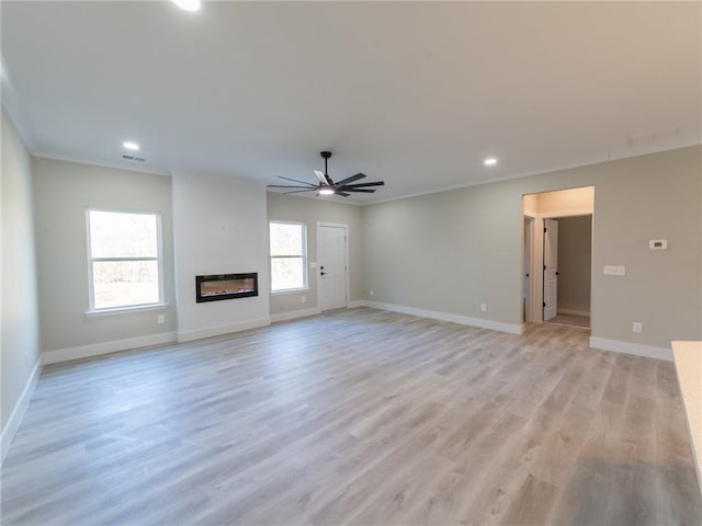 unfurnished living room with ceiling fan, light hardwood / wood-style flooring, and ornamental molding