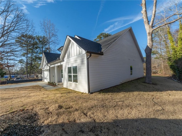 view of property exterior with a garage and a yard