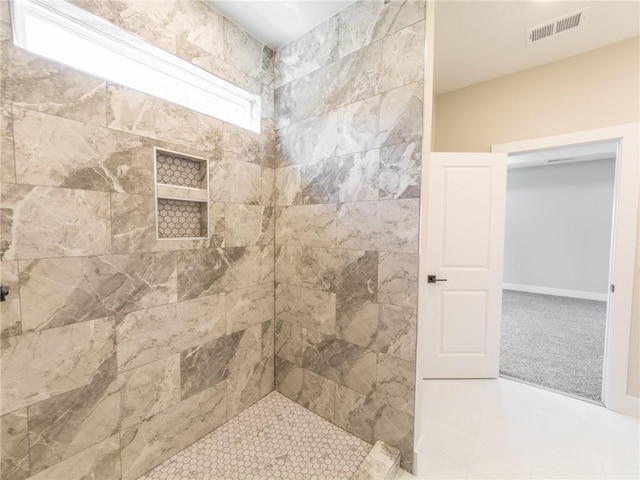 bathroom with tiled shower