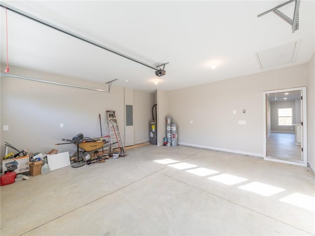 garage featuring water heater, a garage door opener, electric panel, and electric water heater