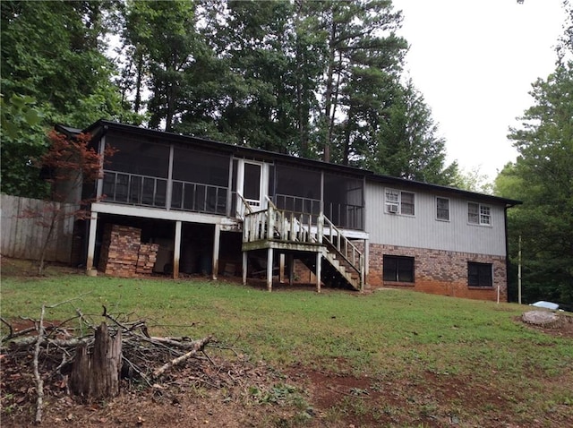 rear view of property with a sunroom and a lawn