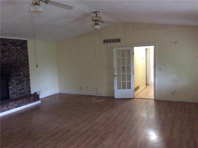 unfurnished living room with hardwood / wood-style flooring, a brick fireplace, ceiling fan, and vaulted ceiling