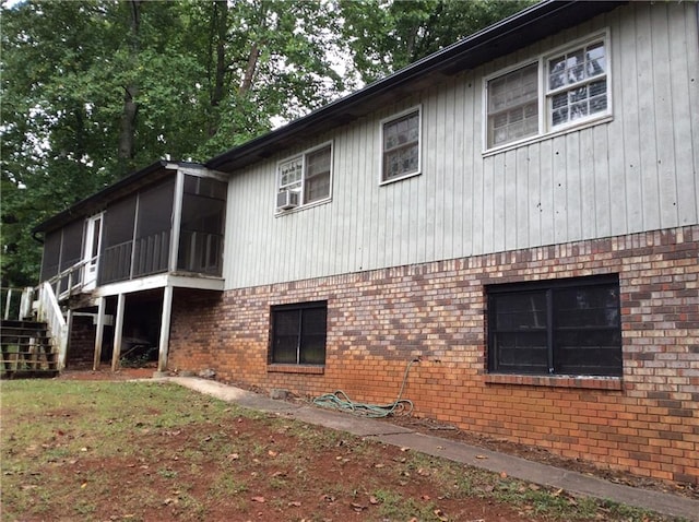 view of property exterior with a sunroom