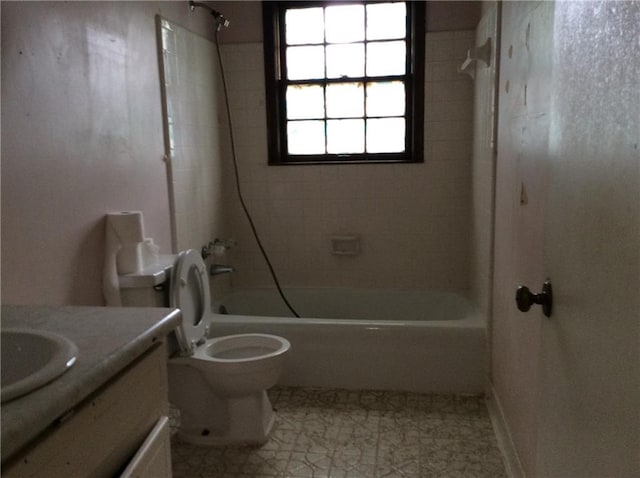 full bathroom featuring vanity, tiled shower / bath combo, toilet, and tile patterned flooring