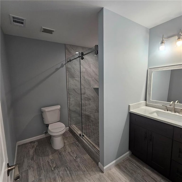 487 Eastside Dr, Dacula, GA 30019 - full bath with toilet, a stall shower, wood finished floors, and vanity
