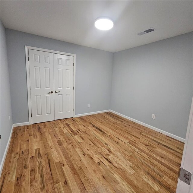 487 Eastside Dr, Dacula, GA 30019 - unfurnished bedroom featuring light wood finished floors, baseboards, and a closet