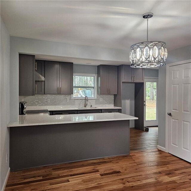 487 Eastside Dr, Dacula, GA 30019 - kitchen with stove, a sink, a peninsula, and healthy amount of natural light