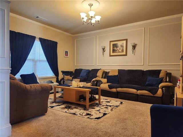 carpeted living area with visible vents, ornamental molding, a decorative wall, and a notable chandelier