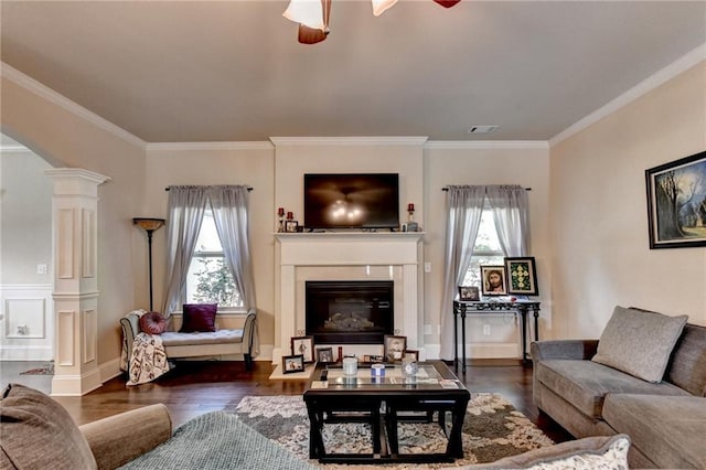 1211 Chapel Estates Way, Dacula, GA 30019 - living room featuring decorative columns, ceiling fan, wood finished floors, ornamental molding, and a glass covered fireplace