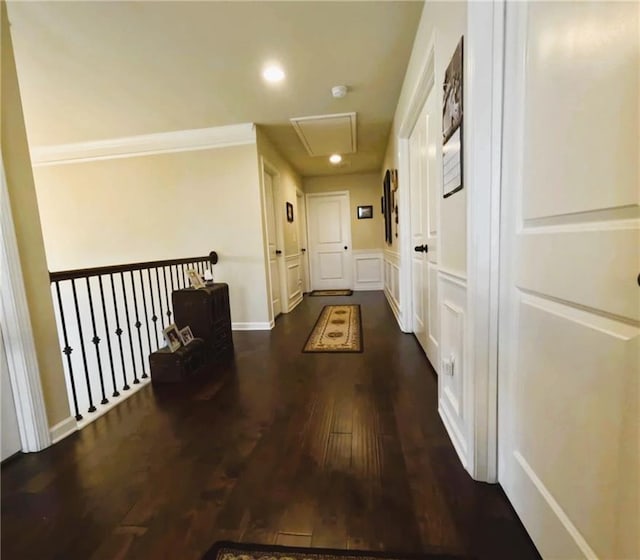 hall with recessed lighting, ornamental molding, attic access, and dark wood-type flooring