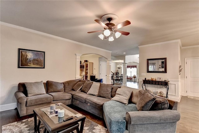 1211 Chapel Estates Way, Dacula, GA 30019 - living area with ornate columns, ceiling fan, arched walkways, wood finished floors, and ornamental molding