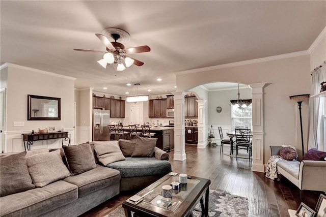 1211 Chapel Estates Way, Dacula, GA 30019 - living area with decorative columns, ceiling fan, arched walkways, crown molding, and dark wood finished floors