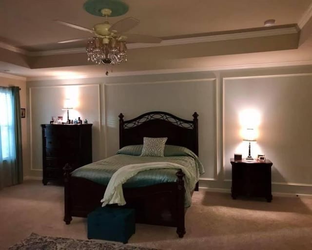 bedroom with a ceiling fan, light colored carpet, and ornamental molding