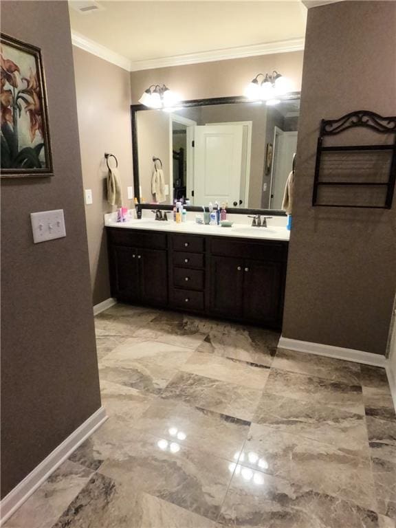 full bathroom with baseboards, ornamental molding, a sink, and double vanity