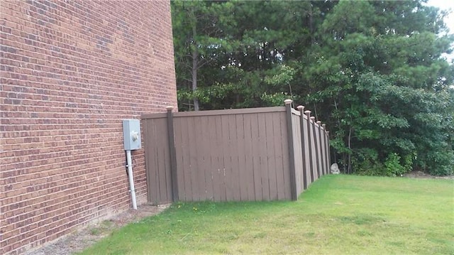 exterior space with a lawn and fence