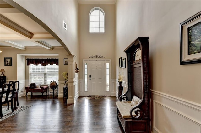 1211 Chapel Estates Way, Dacula, GA 30019 - foyer entrance with arched walkways, crown molding, a wainscoted wall, beamed ceiling, and decorative columns