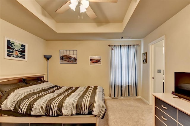 1211 Chapel Estates Way, Dacula, GA 30019 - bedroom featuring a tray ceiling, light carpet, and a ceiling fan