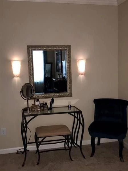sitting room with baseboards and ornamental molding