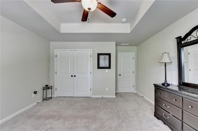 1211 Chapel Estates Way, Dacula, GA 30019 - bedroom with light colored carpet, a raised ceiling, a closet, and ceiling fan