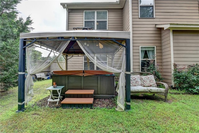 1211 Chapel Estates Way, Dacula, GA 30019 - back of property with a hot tub, a gazebo, and a lawn
