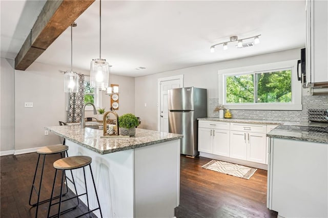 877 Lee Andrews Ave SE, Atlanta, GA 30315 - kitchen with decorative backsplash, white cabinetry, light stone counters, and freestanding refrigerator