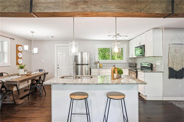 877 Lee Andrews Ave SE, Atlanta, GA 30315 - kitchen with light stone counters, dark wood finished floors, decorative backsplash, and stainless steel appliances
