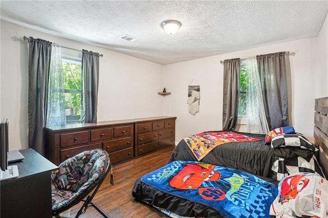 877 Lee Andrews Ave SE, Atlanta, GA 30315 - bedroom with a textured ceiling, wood finished floors, and visible vents