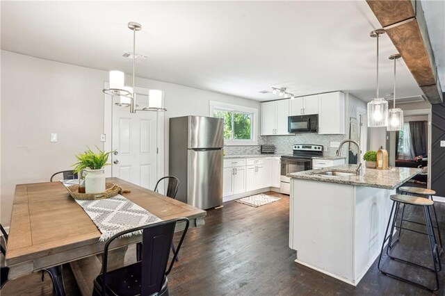 877 Lee Andrews Ave SE, Atlanta, GA 30315 - kitchen with dark wood finished floors, a sink, freestanding refrigerator, black microwave, and electric range oven