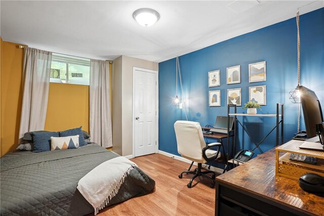 877 Lee Andrews Ave SE, Atlanta, GA 30315 - bedroom with baseboards, wood finished floors, and visible vents