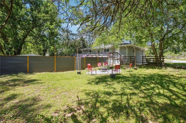 877 Lee Andrews Ave SE, Atlanta, GA 30315 - view of yard featuring a wooden deck, fence, and an outdoor fire pit