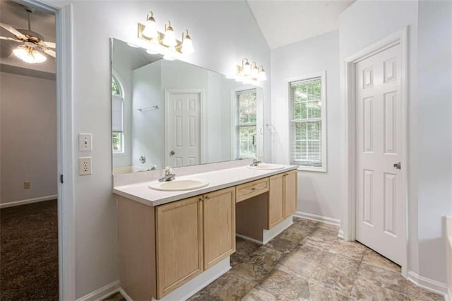 2975 Summit Ln, Monroe, GA 30655 - full bath with double vanity, vaulted ceiling, baseboards, and ceiling fan