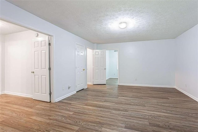 2975 Summit Ln, Monroe, GA 30655 - empty room with wood finished floors, baseboards, and a textured ceiling
