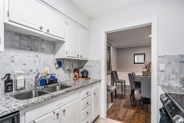 46 Le Parc Fontaine, Lithonia, GA 30038 - kitchen with stainless steel range oven, white cabinets, decorative backsplash, light stone counters, and wood finished floors