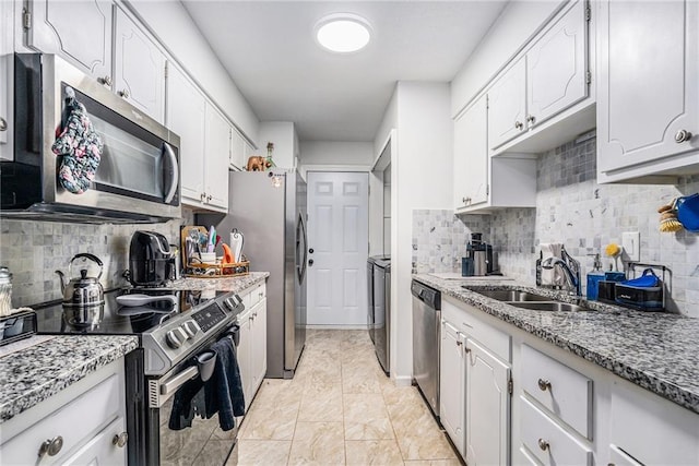 46 Le Parc Fontaine, Lithonia, GA 30038 - kitchen featuring appliances with stainless steel finishes, separate washer and dryer, decorative backsplash, and white cabinets