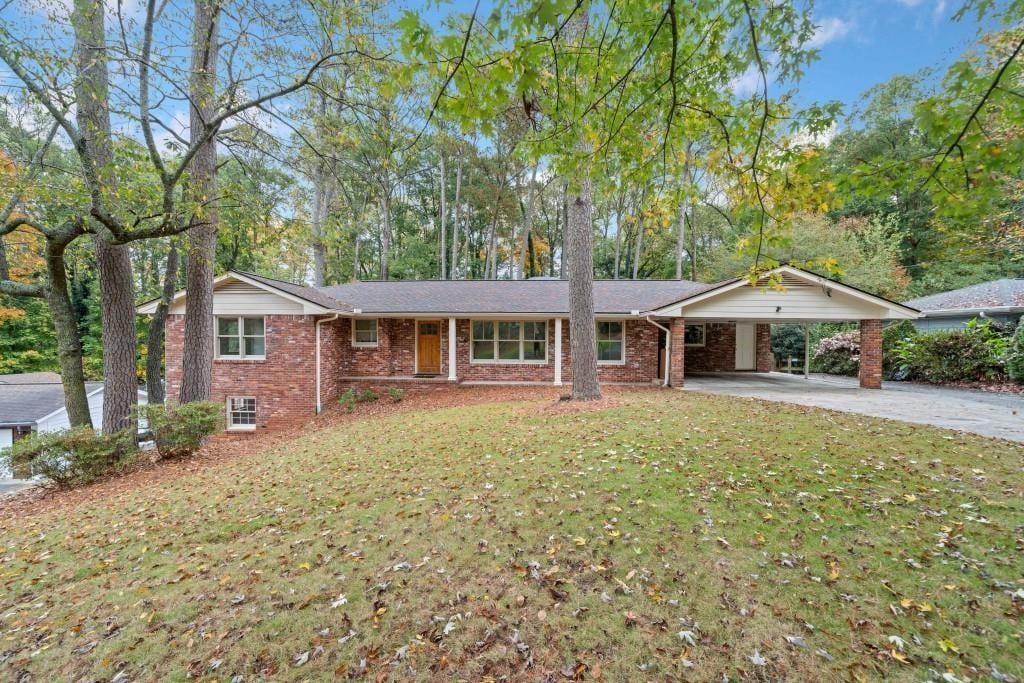 single story home with a carport and a front lawn