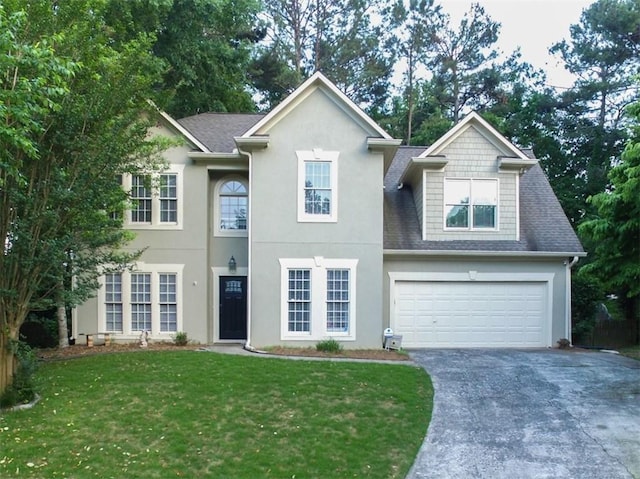 view of front of property with a front yard and a garage