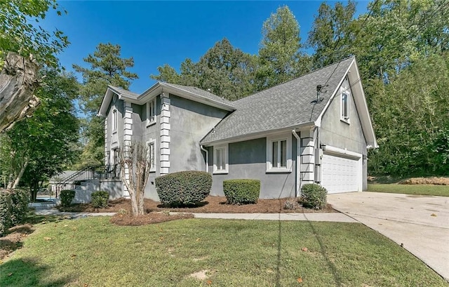 view of front of house with a garage and a front lawn