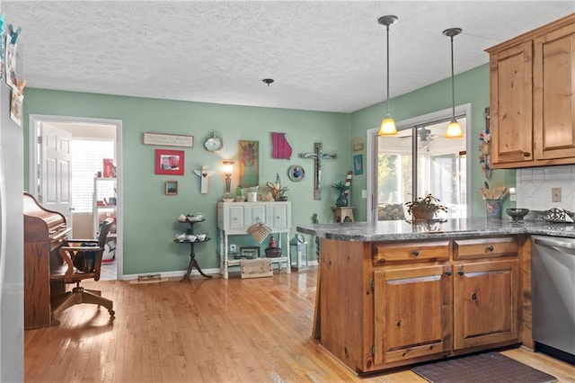 kitchen with dishwasher, brown cabinetry, light wood-style flooring, and decorative backsplash