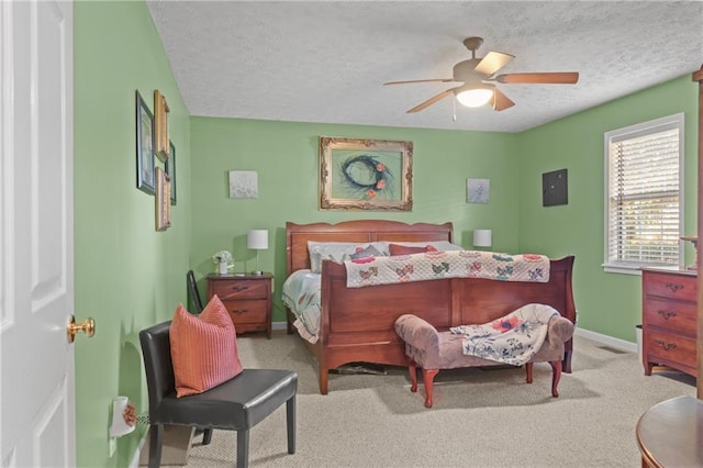 bedroom featuring carpet floors, visible vents, a ceiling fan, a textured ceiling, and baseboards